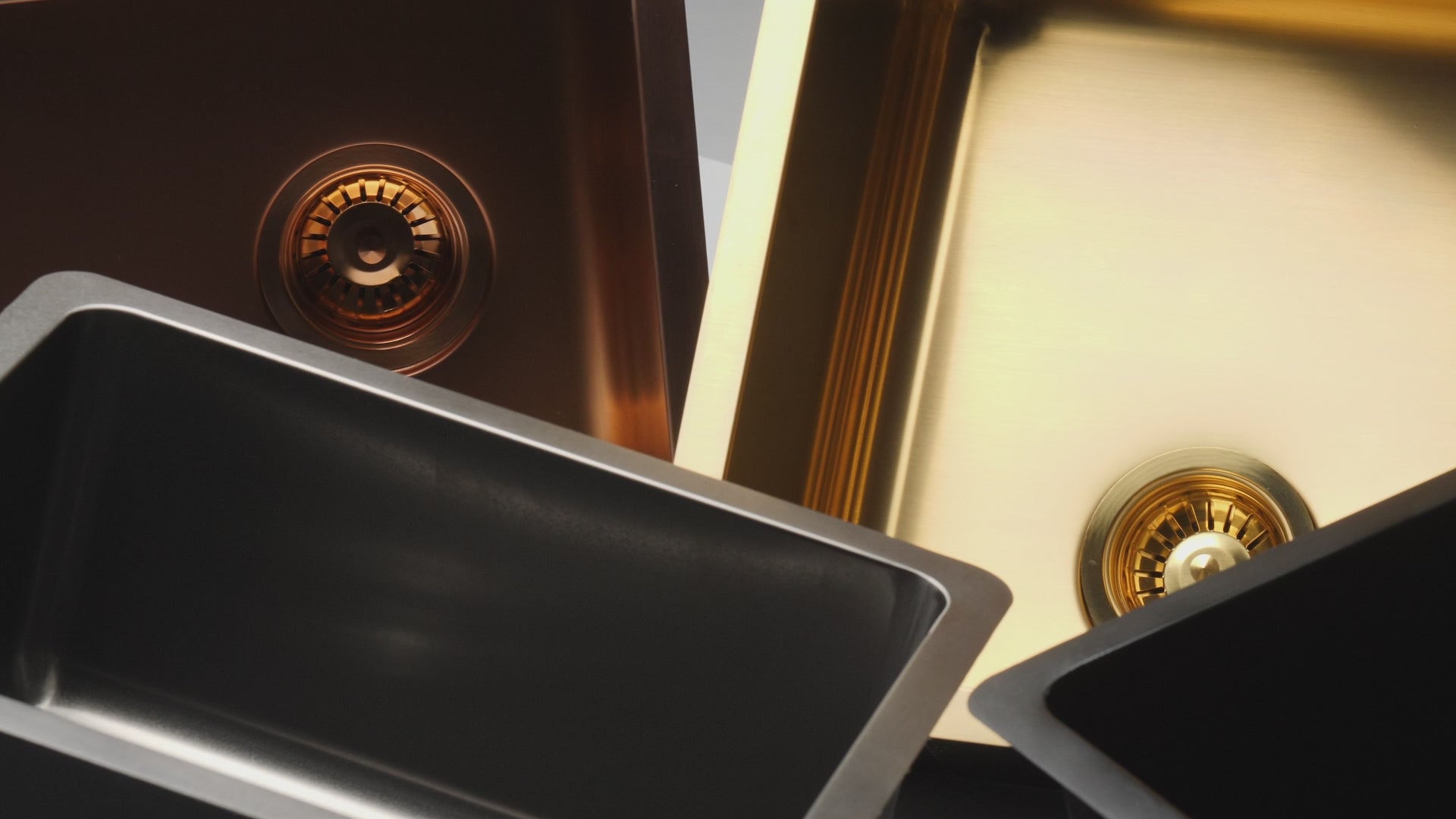 Cinematic video of four Titan medium bowl kitchen sinks in rose gold, gold, gunmetal, and matte black, with the camera panning over each sink to highlight their stunning finishes.